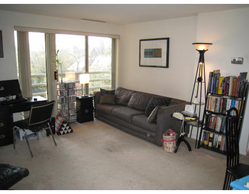 20 Webster Street, Unit 401 Brookline, MA 02446 - Photo 3 of 7 a living room with furniture a bookshelf and a large window