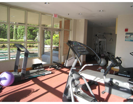 20 Webster Street, Unit 401 Brookline, MA 02446 - Photo 5 of 7 a room with gym equipment and large windows