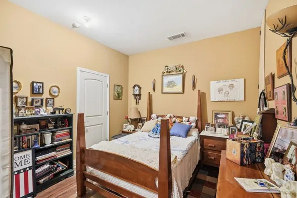 a bed room with a bed and a book shelf