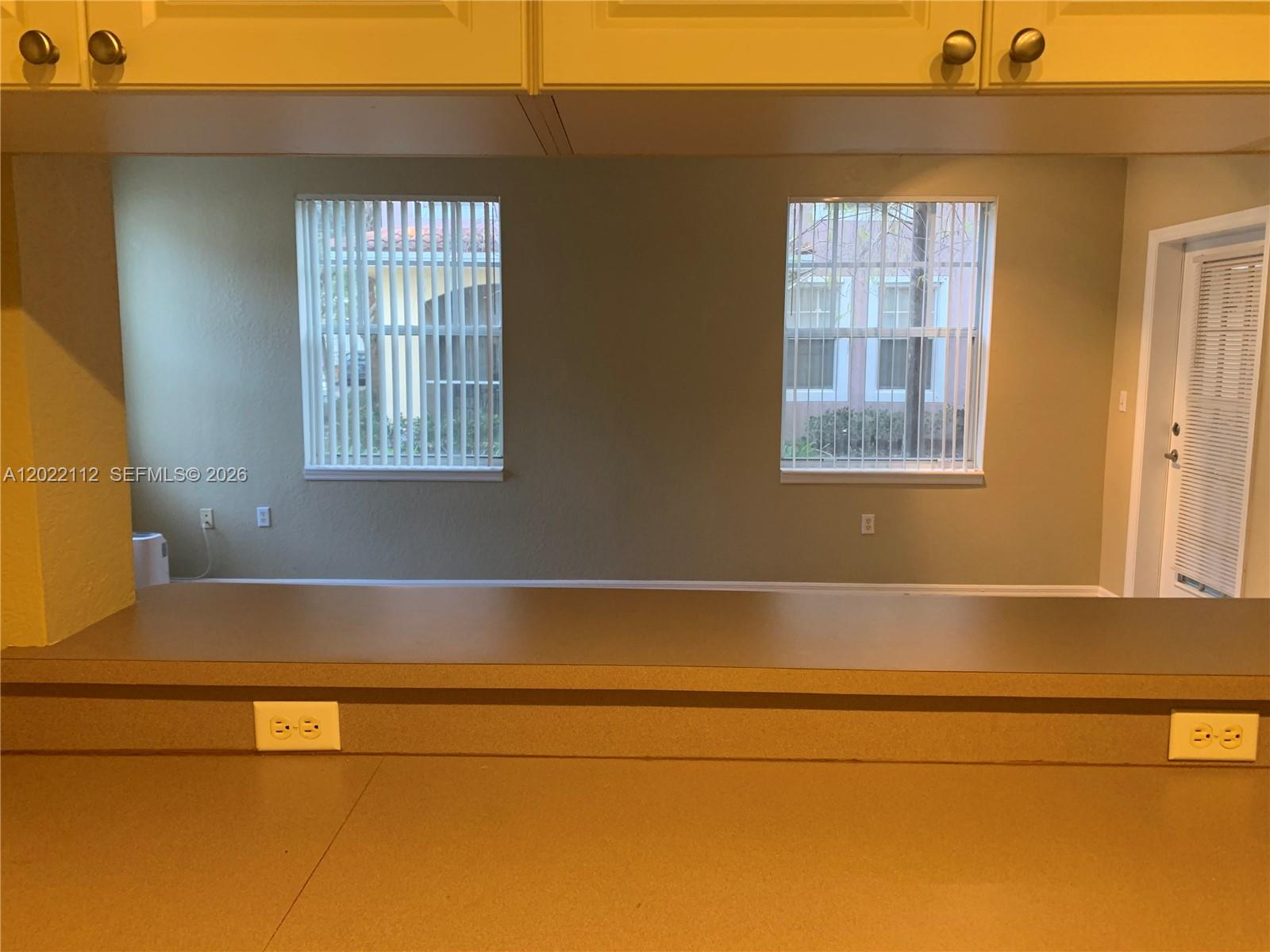 6572 West Sample Road, Unit 6572 Coral Springs, FL 33067 - Photo 5 of 17 a view of an empty room with a window