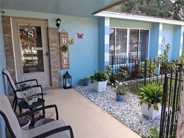 a view of a house with backyard and sitting area
