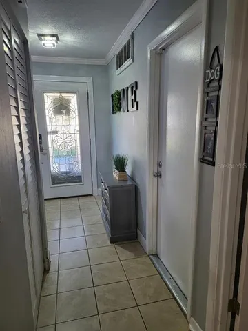 a kitchen with granite countertop a refrigerator and a stove top oven