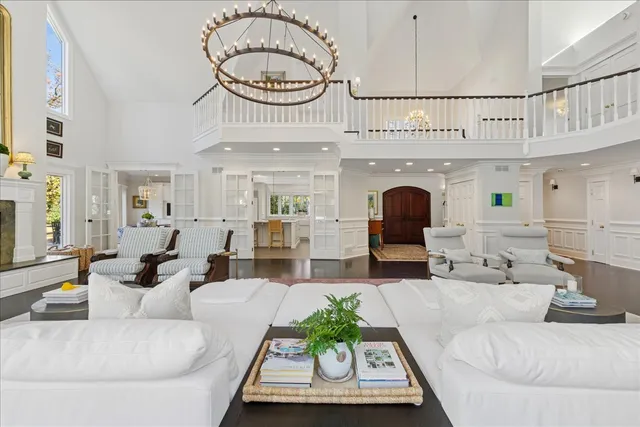 a living room with furniture fireplace and kitchen view