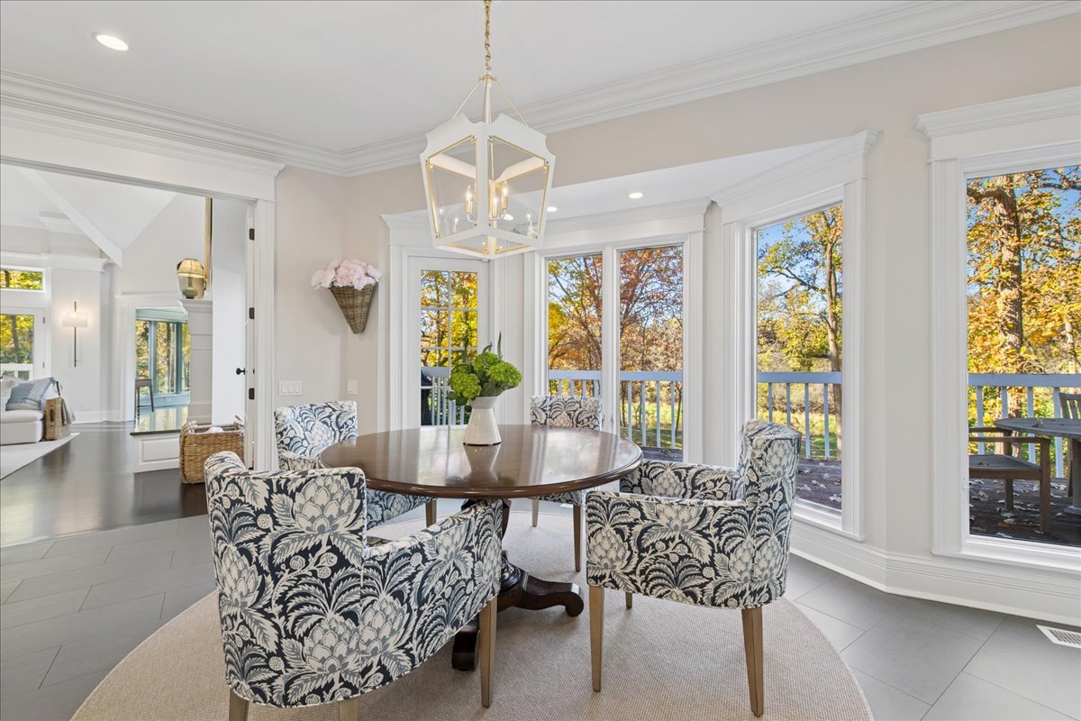 166 North Buckley Road Barrington Hills, IL 60010 - Photo 25 of 86 a dining room with furniture a chandelier and wooden floor