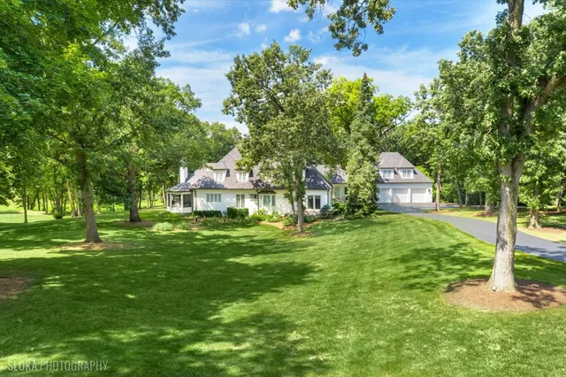 a living room with fireplace furniture and a large window
