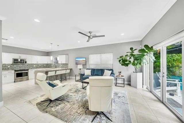 a living room with furniture and kitchen view