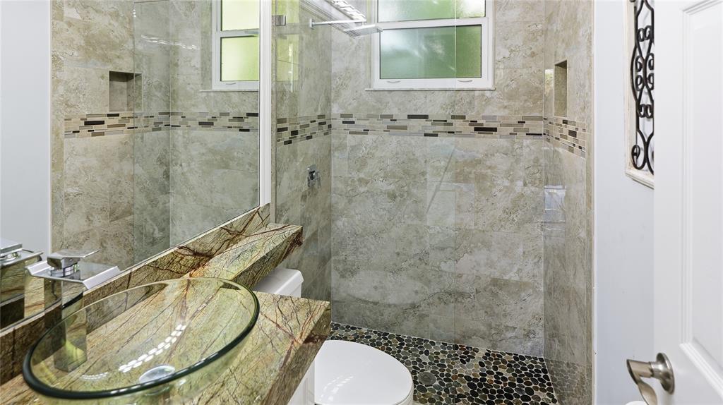 10141 Umberland Place Boca Raton, FL 33428 - Photo 21 of 28 a bathroom with a sink toilet and shower