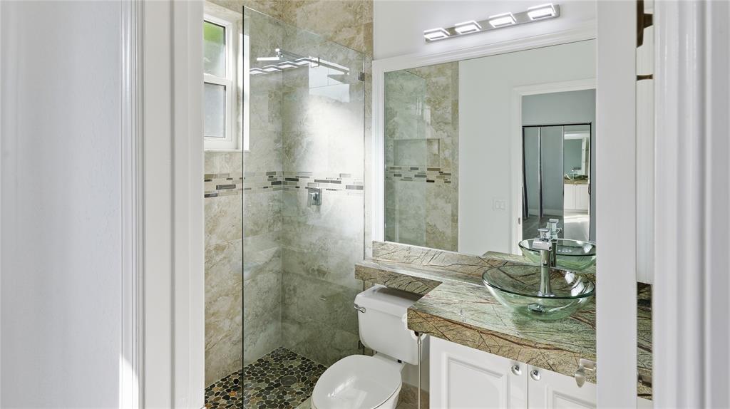 10141 Umberland Place Boca Raton, FL 33428 - Photo 23 of 28 a bathroom with a granite countertop sink toilet and shower