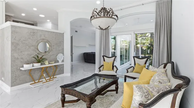 a living room with furniture and a chandelier