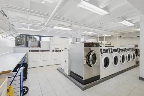 a utility room with cabinets dryer and washer
