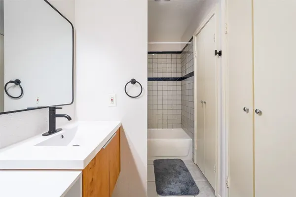 a bathroom with a bathtub and shower