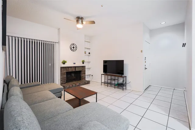 a living room with furniture a rug and a flat screen tv