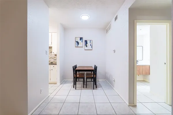 a view of a livingroom with furniture and a hallway
