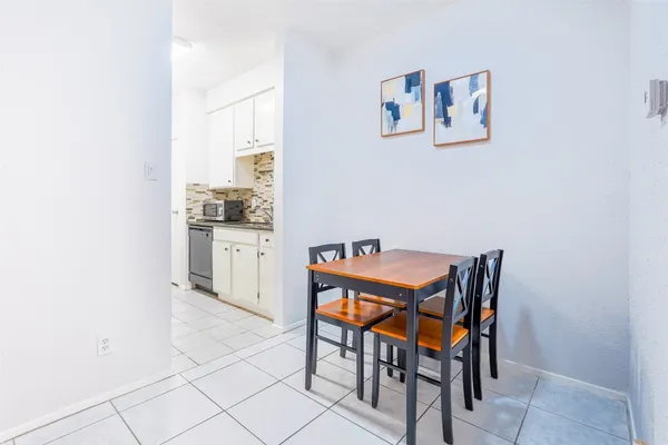 a room with furniture and view of kitchen