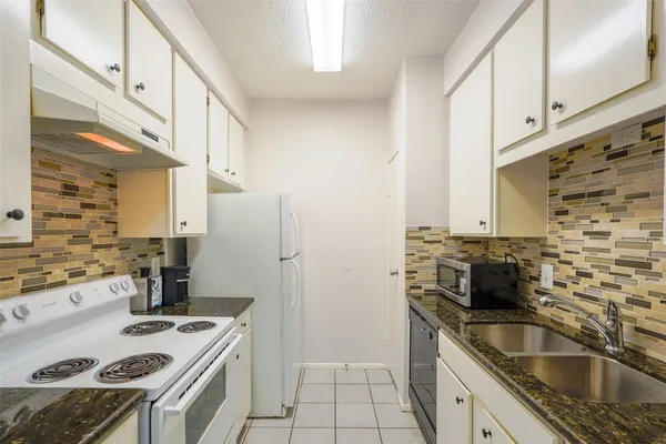 a kitchen that has a sink and a stove