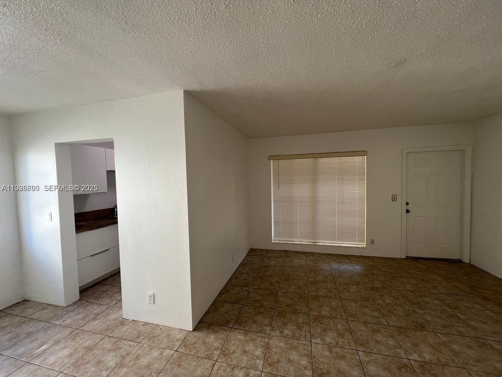 105 Northeast 12th Avenue, Unit 17 Hallandale Beach, FL 33009 - Photo 3 of 11 an empty room with windows