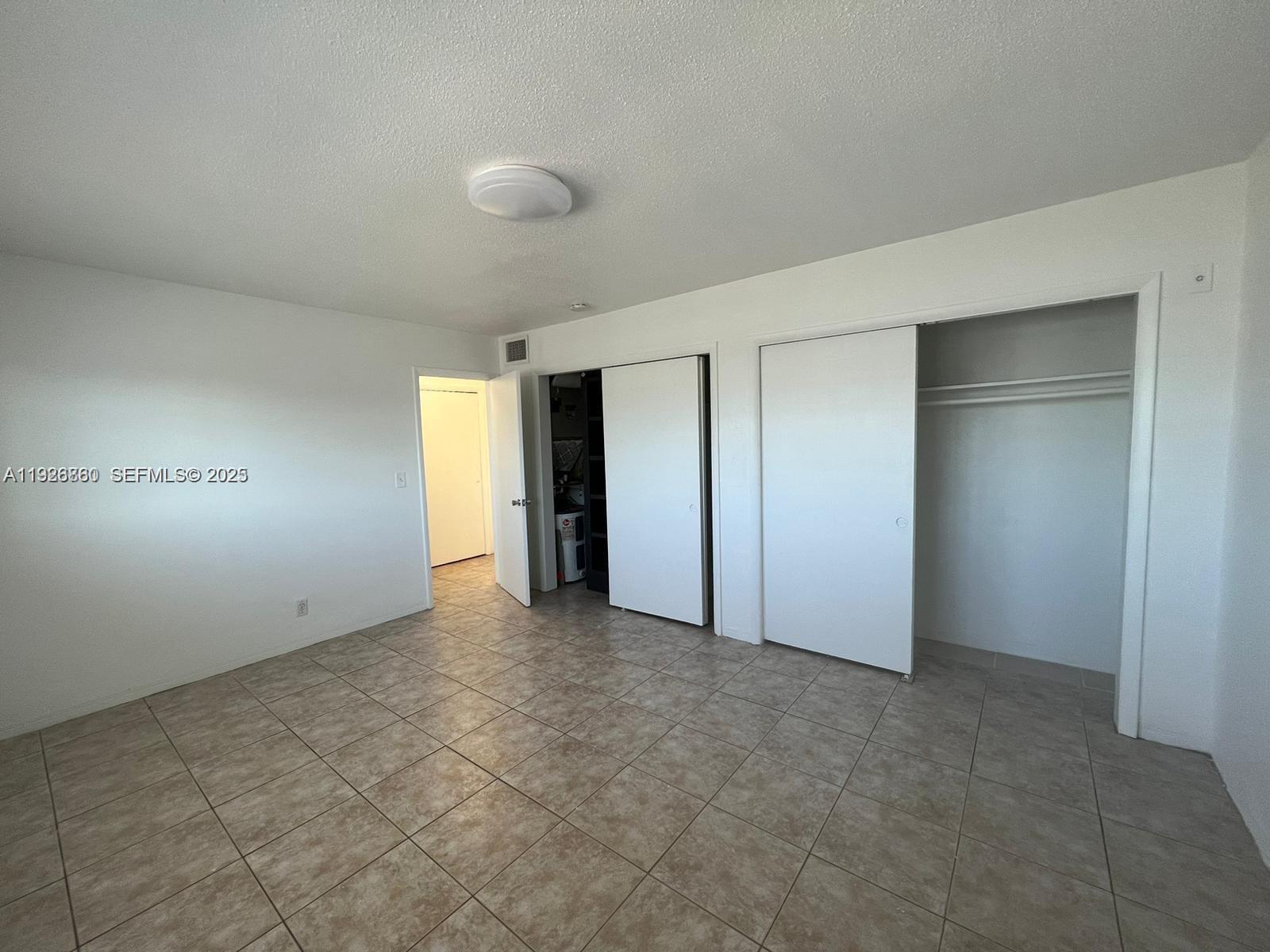105 Northeast 12th Avenue, Unit 17 Hallandale Beach, FL 33009 - Photo 5 of 11 a view of an empty room and closet area