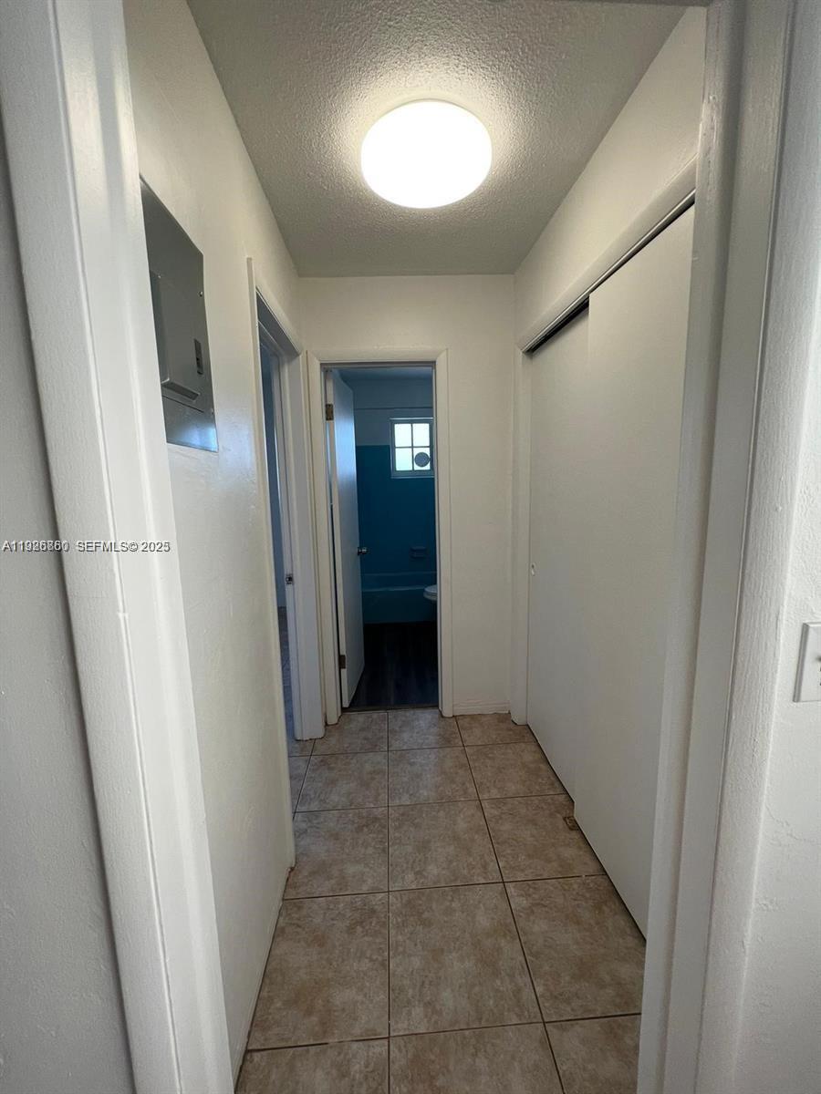 105 Northeast 12th Avenue, Unit 17 Hallandale Beach, FL 33009 - Photo 6 of 11 a view of a hallway with wooden floor