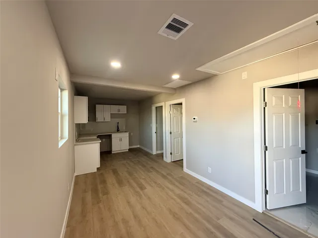 a view of a kitchen with a sink and cabinets