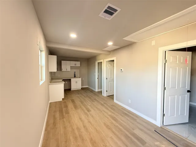 a bathroom with a granite countertop sink a toilet and shower