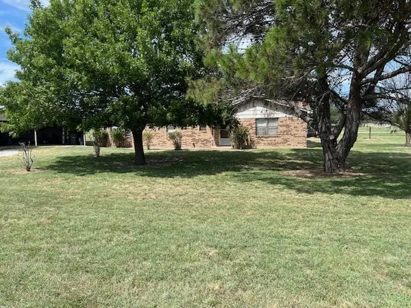 a house with a trees in front of it