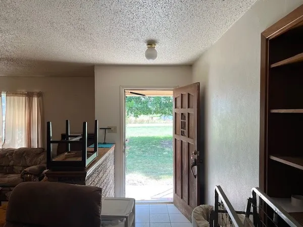 a living room with furniture chandelier and a window