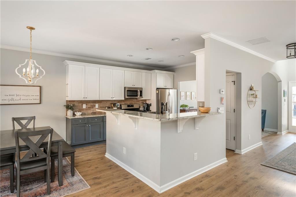 503 Pinnacle Court Canton, GA 30115 - Photo 17 of 51 a kitchen with stainless steel appliances a refrigerator a stove a sink dishwasher with a dining table and chairs