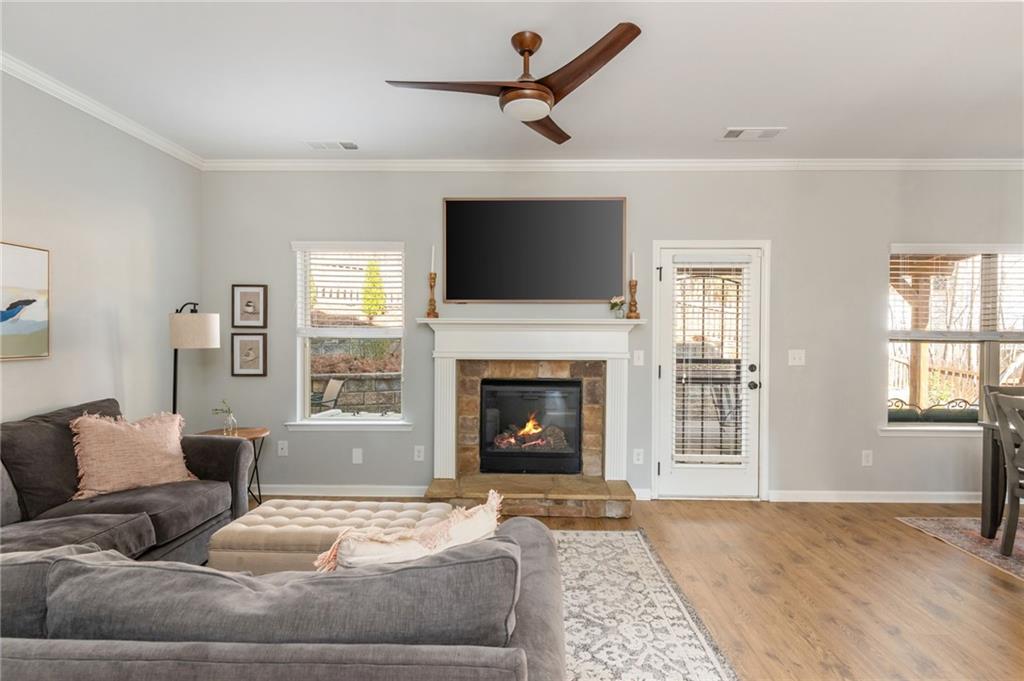 503 Pinnacle Court Canton, GA 30115 - Photo 25 of 51 a living room with furniture a fireplace and a flat screen tv