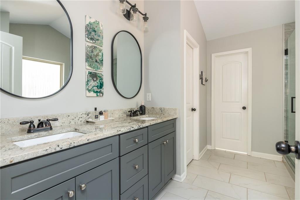 503 Pinnacle Court Canton, GA 30115 - Photo 34 of 51 a en suite bathroom with a granite countertop double vanity sink and a mirror