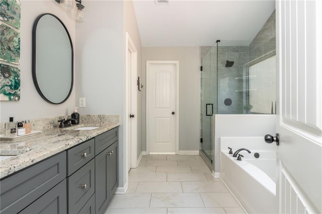 503 Pinnacle Court Canton, GA 30115 - Photo 35 of 51 a bathroom with a tub sink and mirror