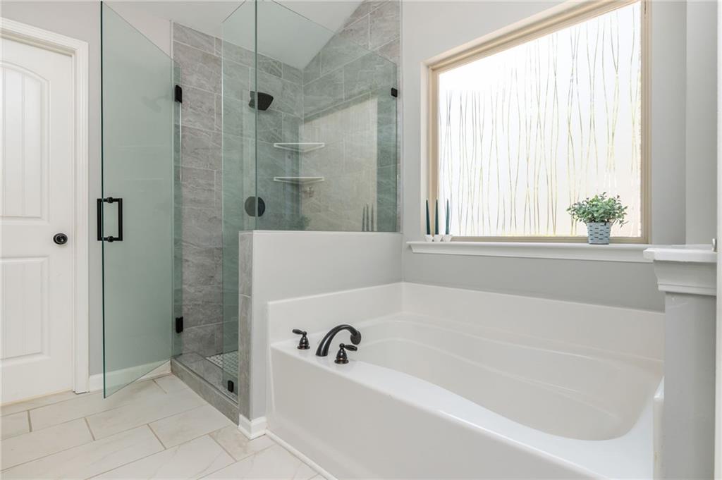 503 Pinnacle Court Canton, GA 30115 - Photo 36 of 51 a bathroom with a bathtub and shower