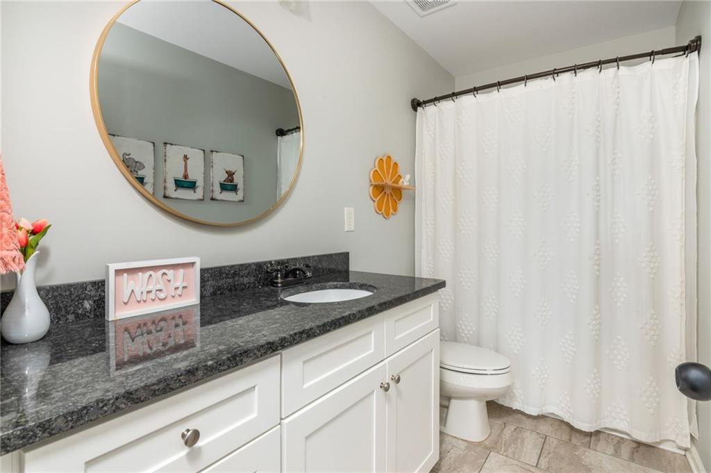 503 Pinnacle Court Canton, GA 30115 - Photo 41 of 51 a bathroom with a granite countertop sink and a mirror