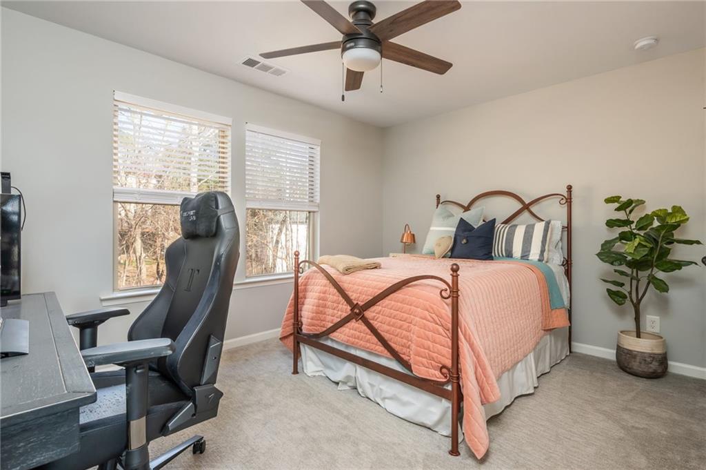 503 Pinnacle Court Canton, GA 30115 - Photo 42 of 51 a bedroom with a bed and a potted plant