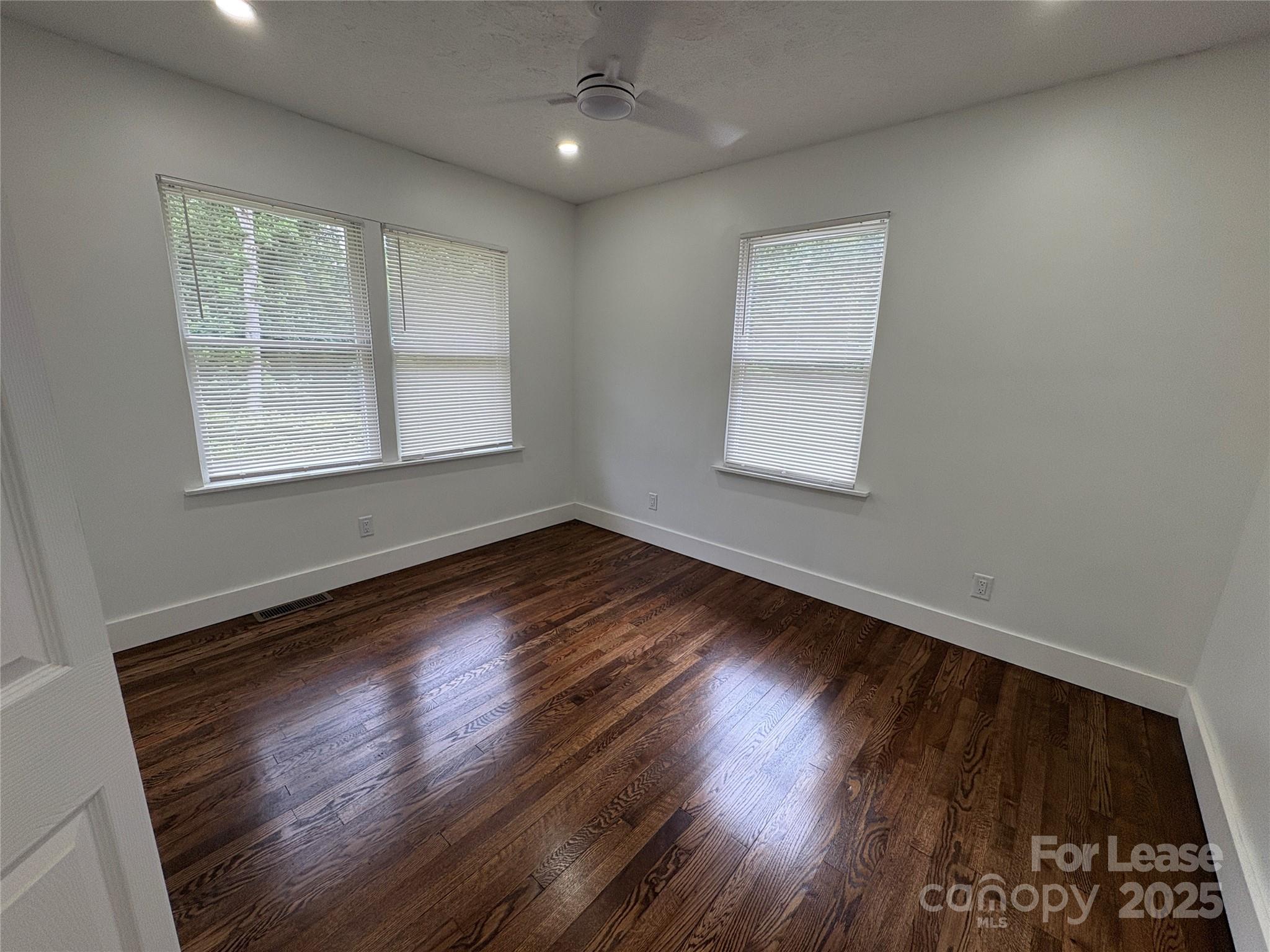 1175 Kilpatrick Road Hendersonville, NC 28739 - Photo 17 of 34 an empty room with wooden floor and windows