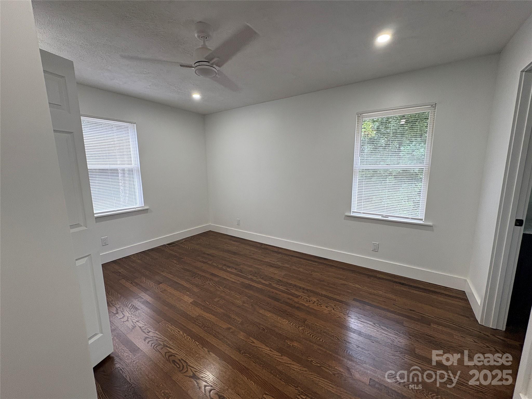 1175 Kilpatrick Road Hendersonville, NC 28739 - Photo 19 of 34 a view of an empty room with wooden floor and a window
