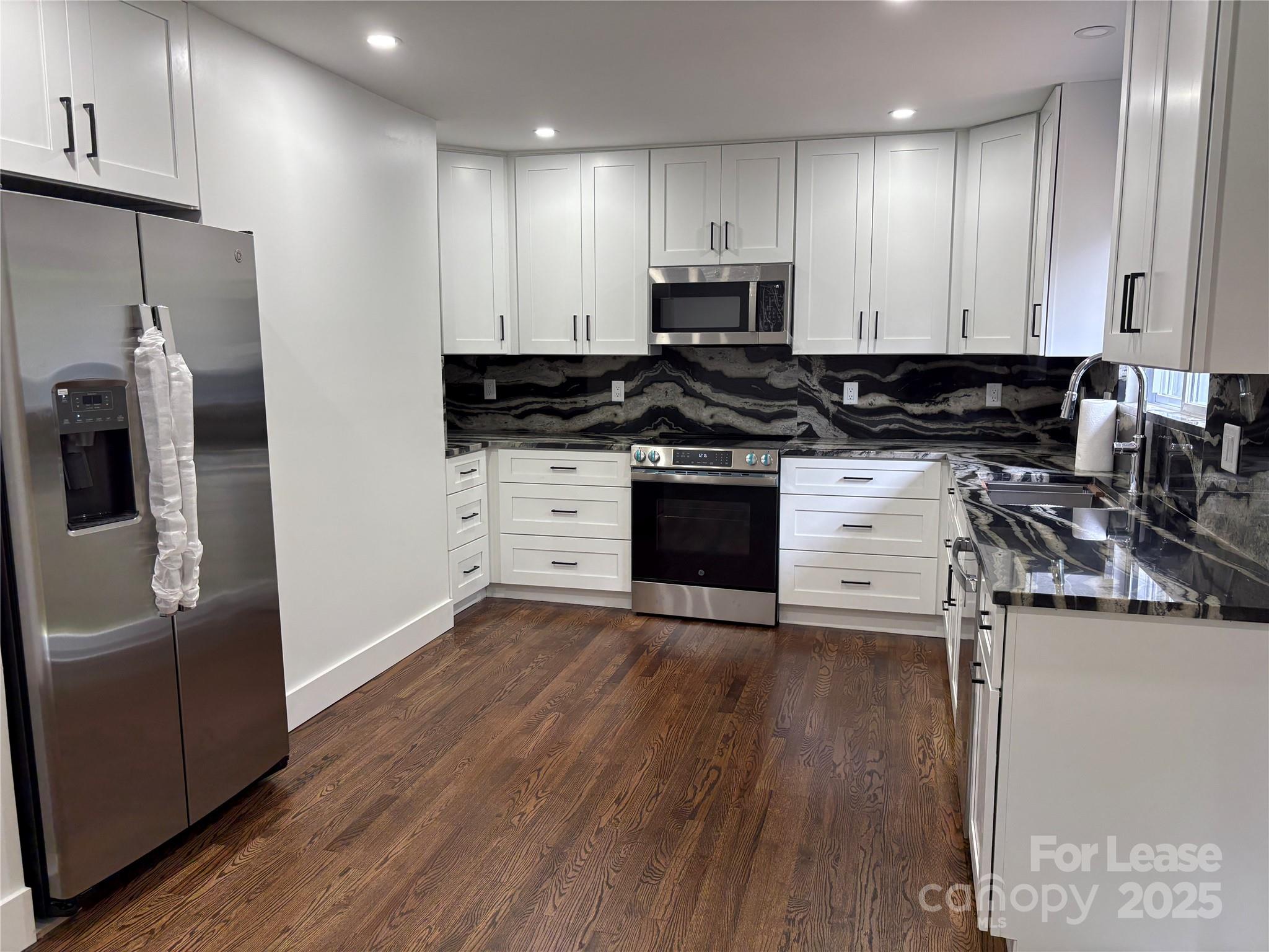 1175 Kilpatrick Road Hendersonville, NC 28739 - Photo 2 of 34 a kitchen with stainless steel appliances a stove a sink and a refrigerator