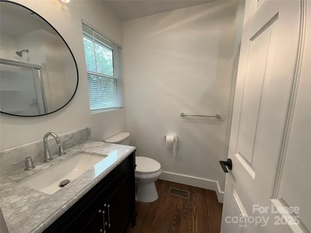 a bathroom with a glass shower door