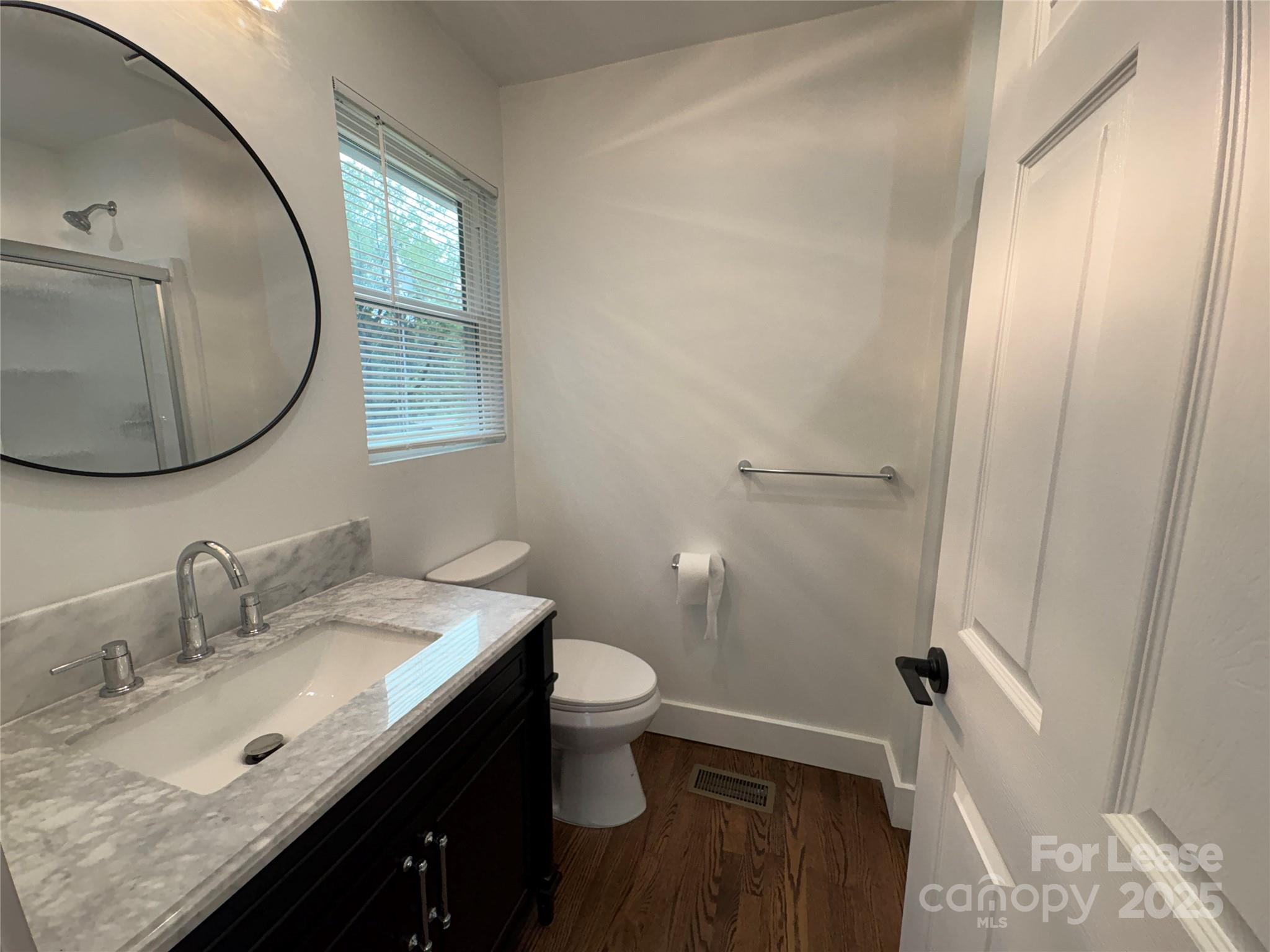 1175 Kilpatrick Road Hendersonville, NC 28739 - Photo 22 of 34 a bathroom with a granite countertop sink toilet and a mirror