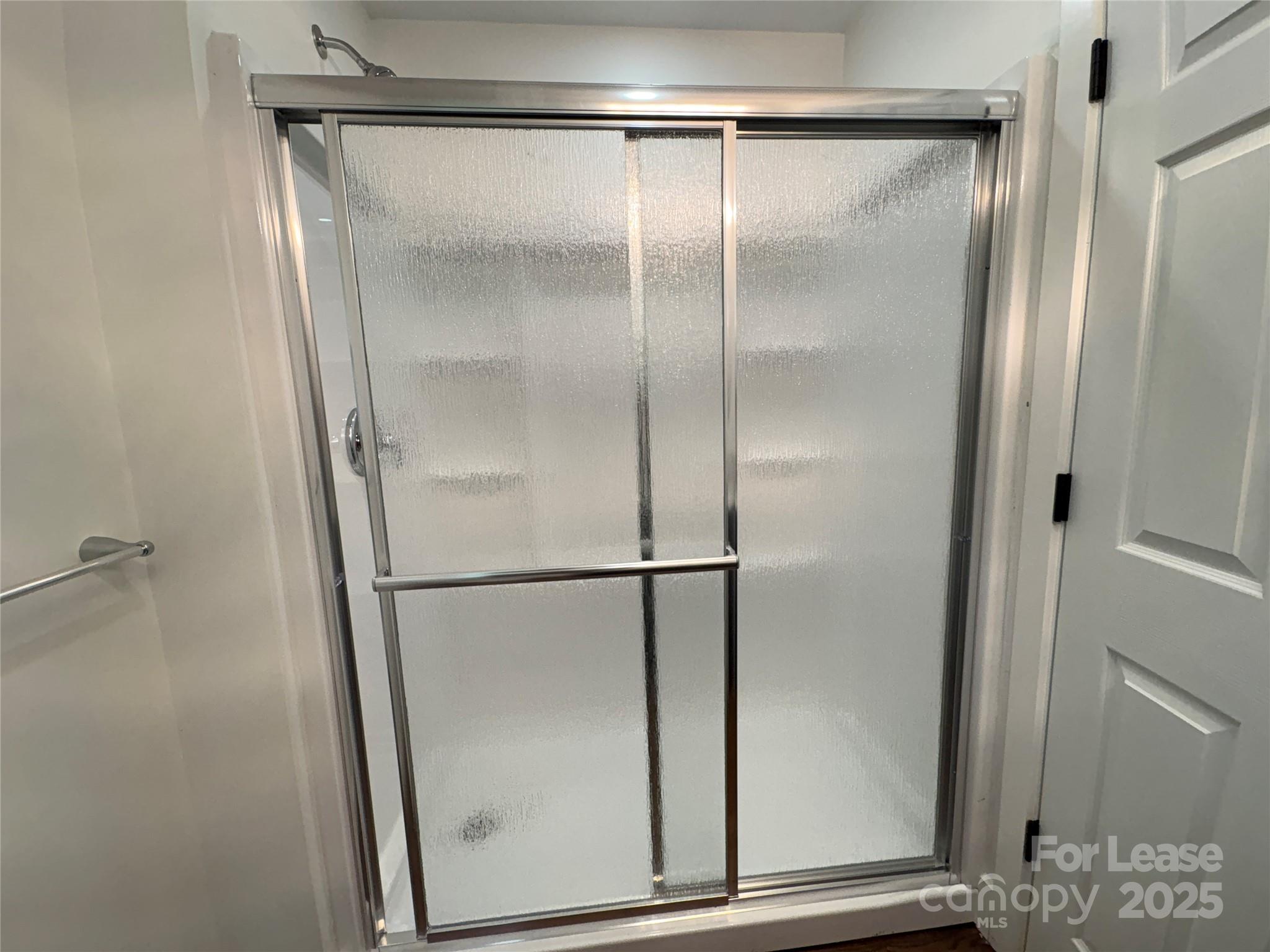 1175 Kilpatrick Road Hendersonville, NC 28739 - Photo 23 of 34 a bathroom with a glass shower door
