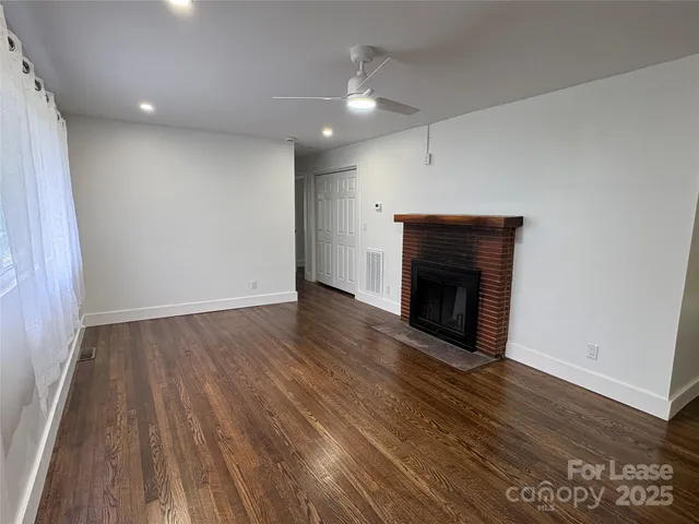 wooden floor in an empty room with a fireplace