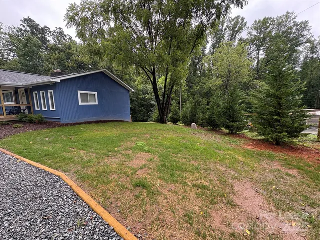 a backyard of a house with plants and entertaining space