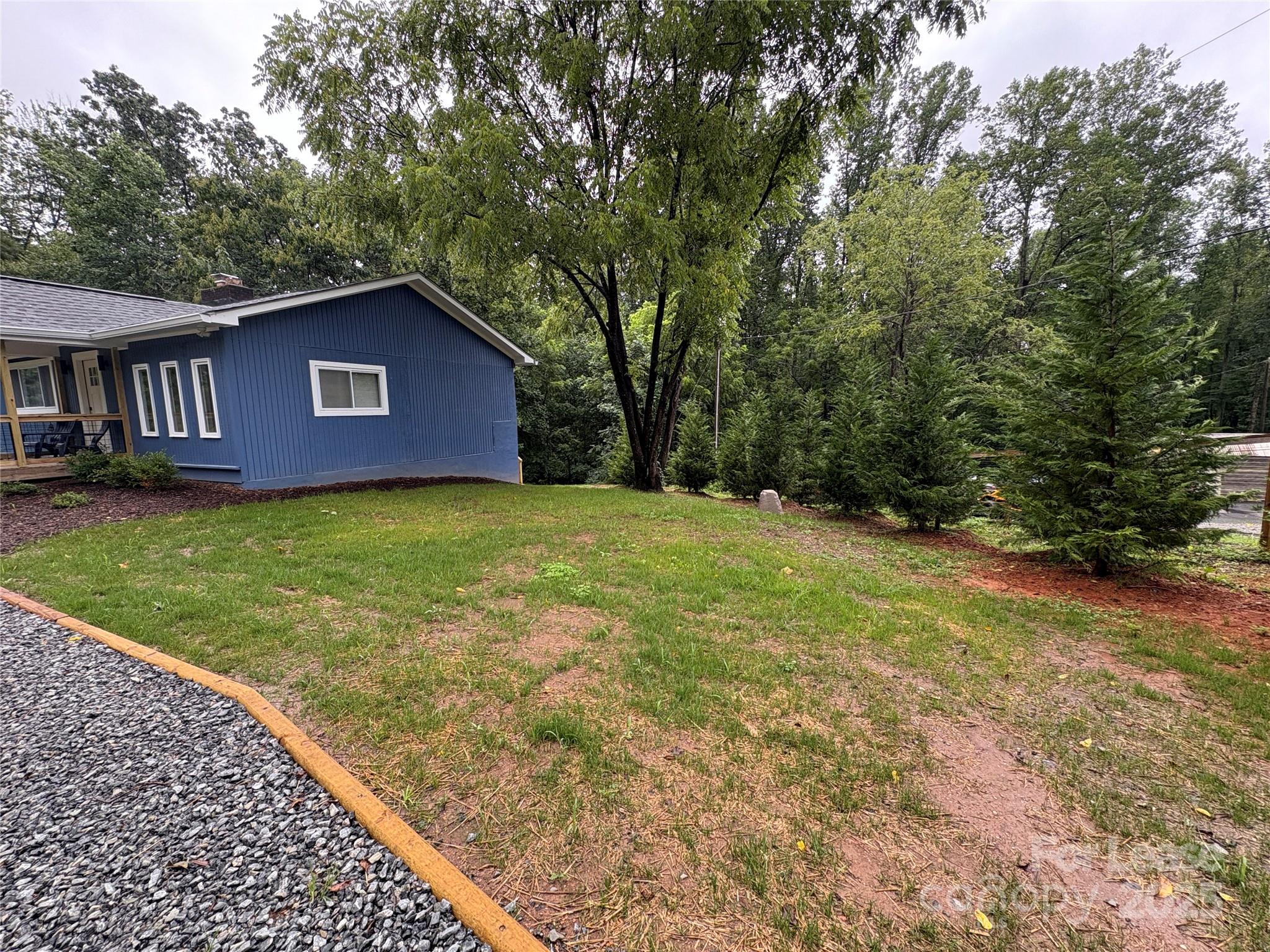 1175 Kilpatrick Road Hendersonville, NC 28739 - Photo 31 of 34 a house with huge green field in front of it