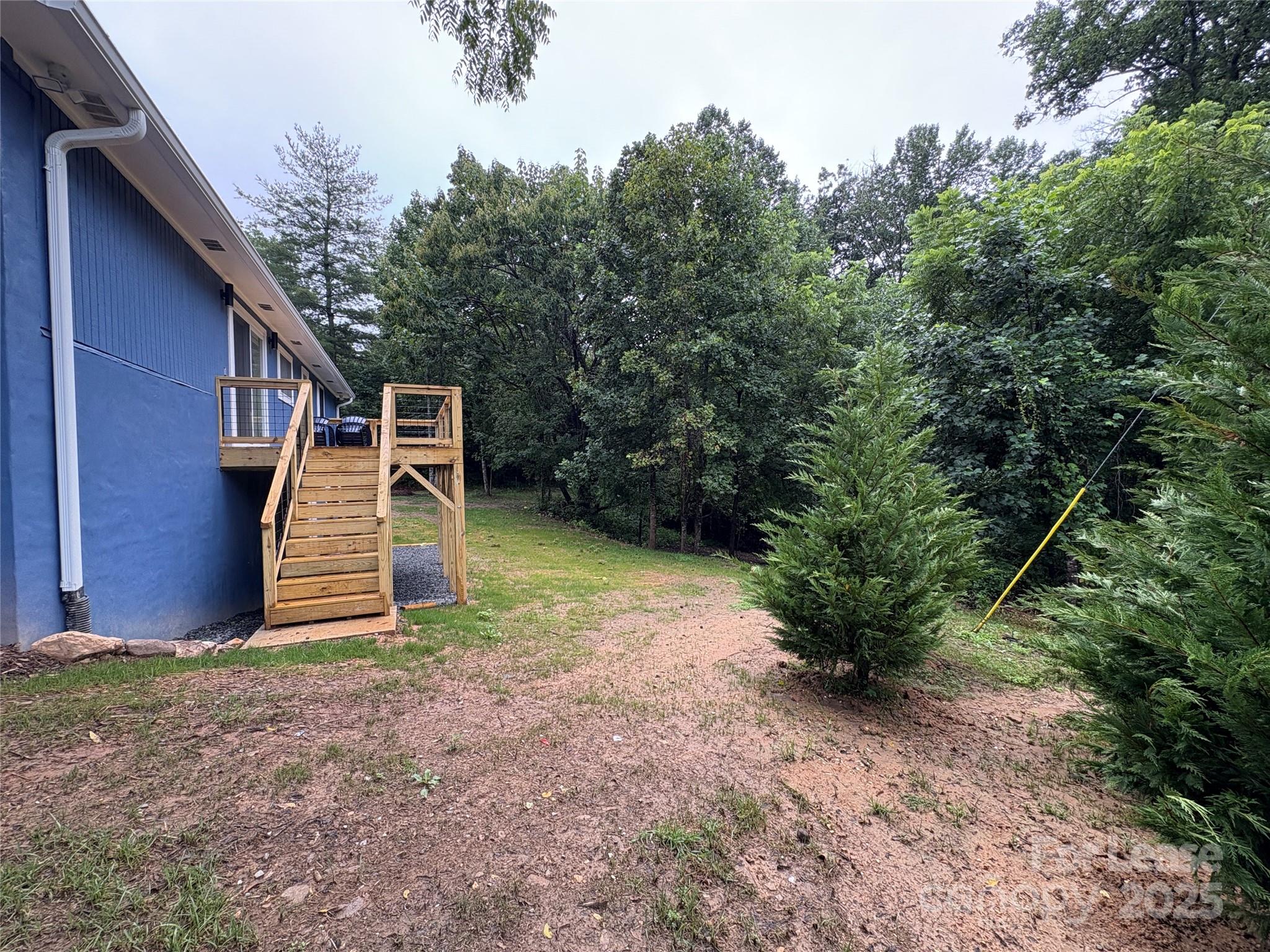 1175 Kilpatrick Road Hendersonville, NC 28739 - Photo 32 of 34 a backyard of a house with plants and entertaining space