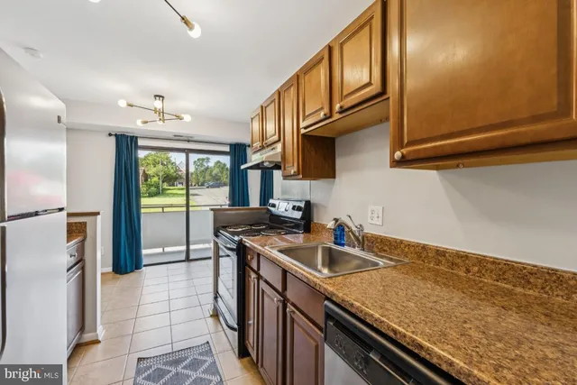 a kitchen with stainless steel appliances a stove a microwave and a refrigerator