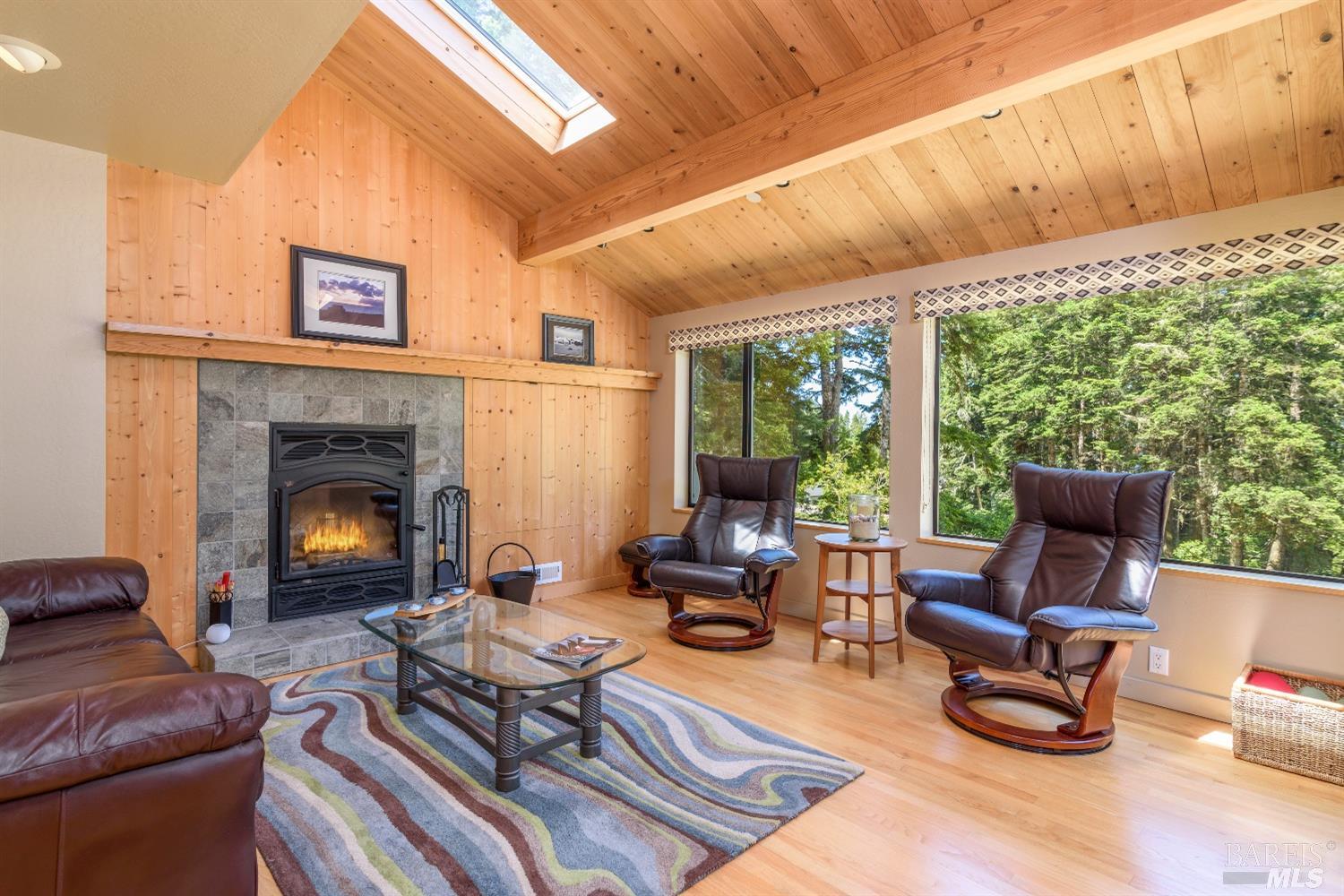 398 Long Meadow Road The Sea Ranch, CA 95497 - Photo 1 of 1 a living room with furniture a fireplace and a large window