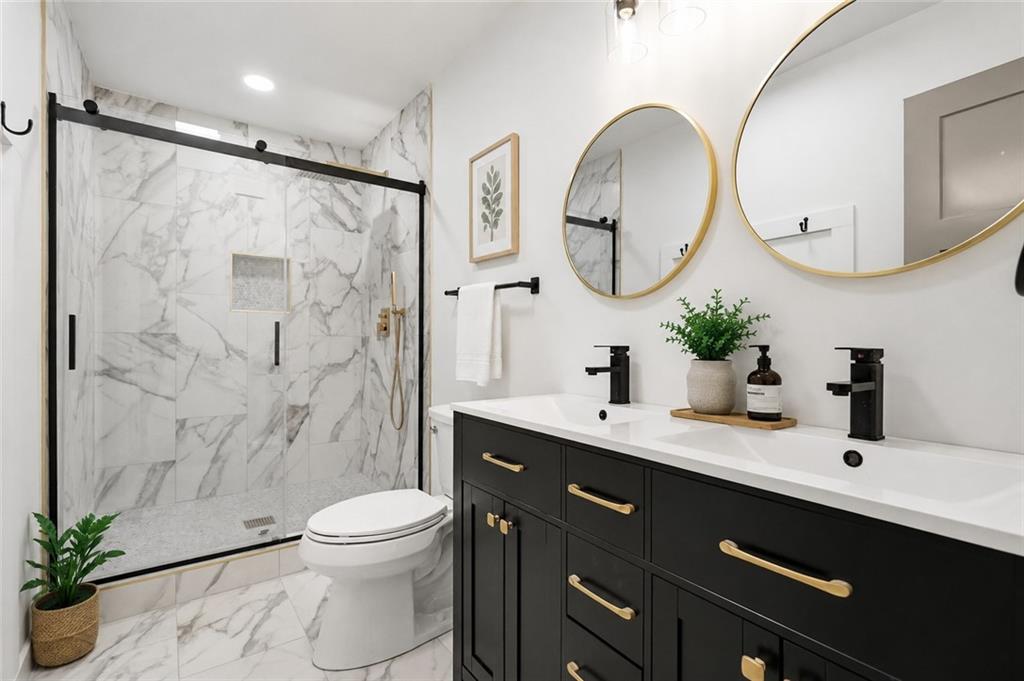 26 Ridgeview Court Dahlonega, GA 30533 - Photo 2 of 23 a bathroom with a sink a toilet and a mirror