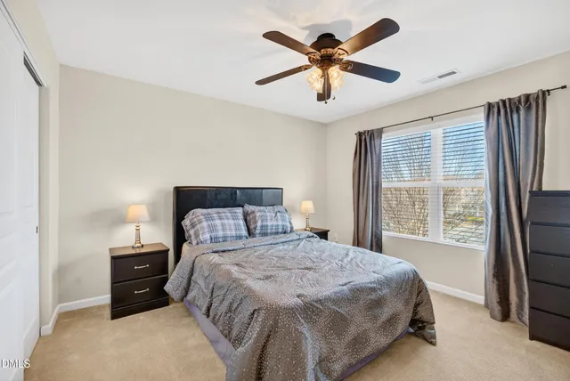a bedroom with a large bed and a large window