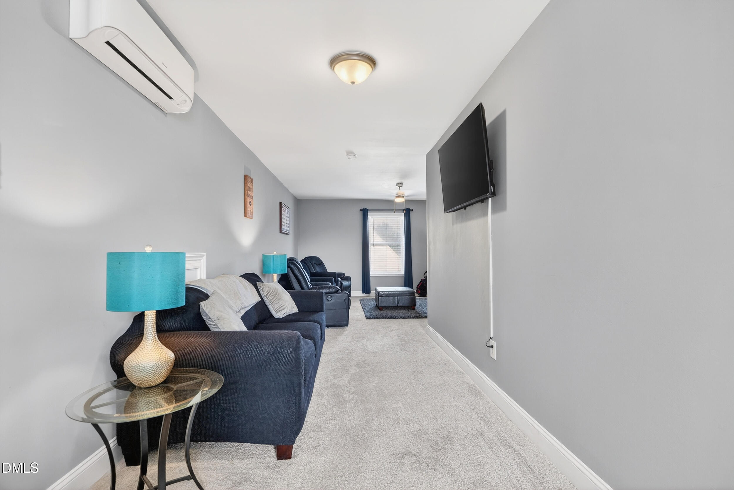 8144 Hovingham Way Raleigh, NC 27616 - Photo 23 of 37 a living room with furniture and a flat screen tv