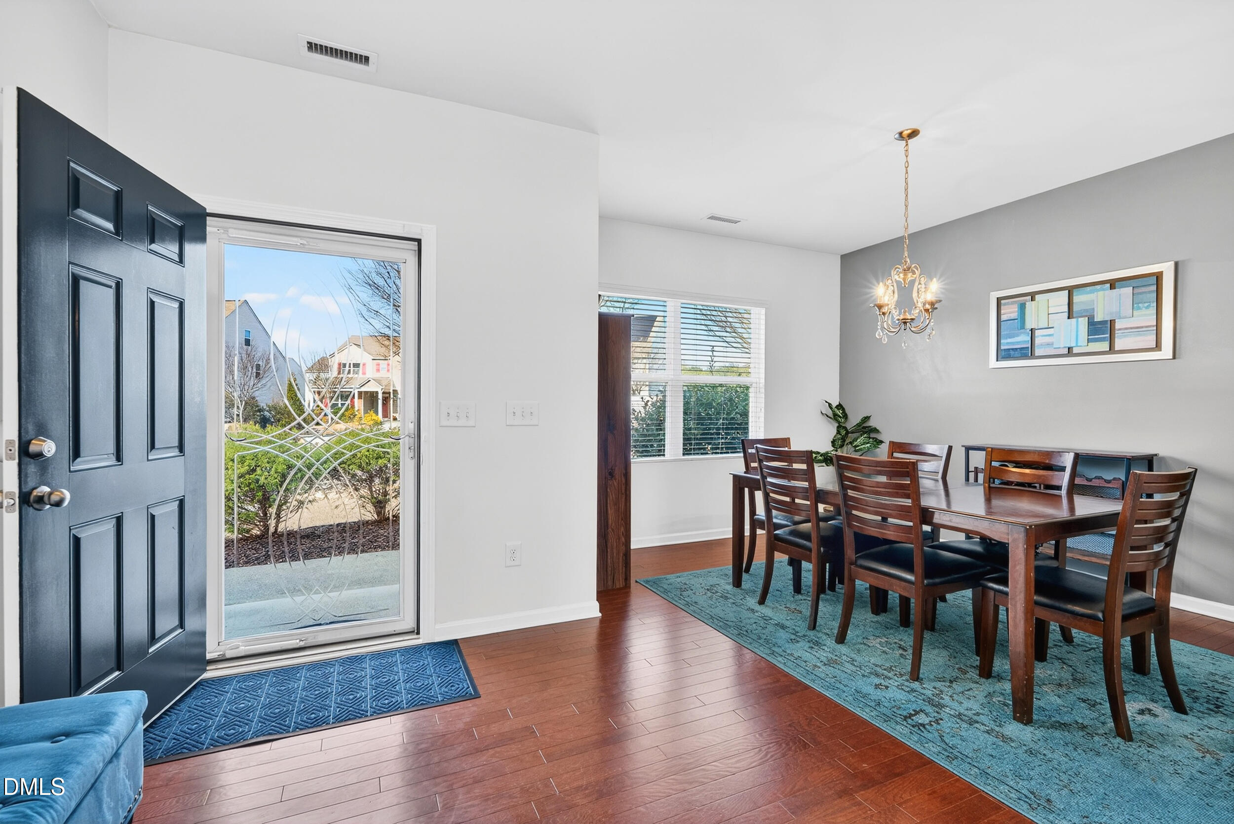 8144 Hovingham Way Raleigh, NC 27616 - Photo 3 of 37 a view of a dining room with furniture window and wooden floor
