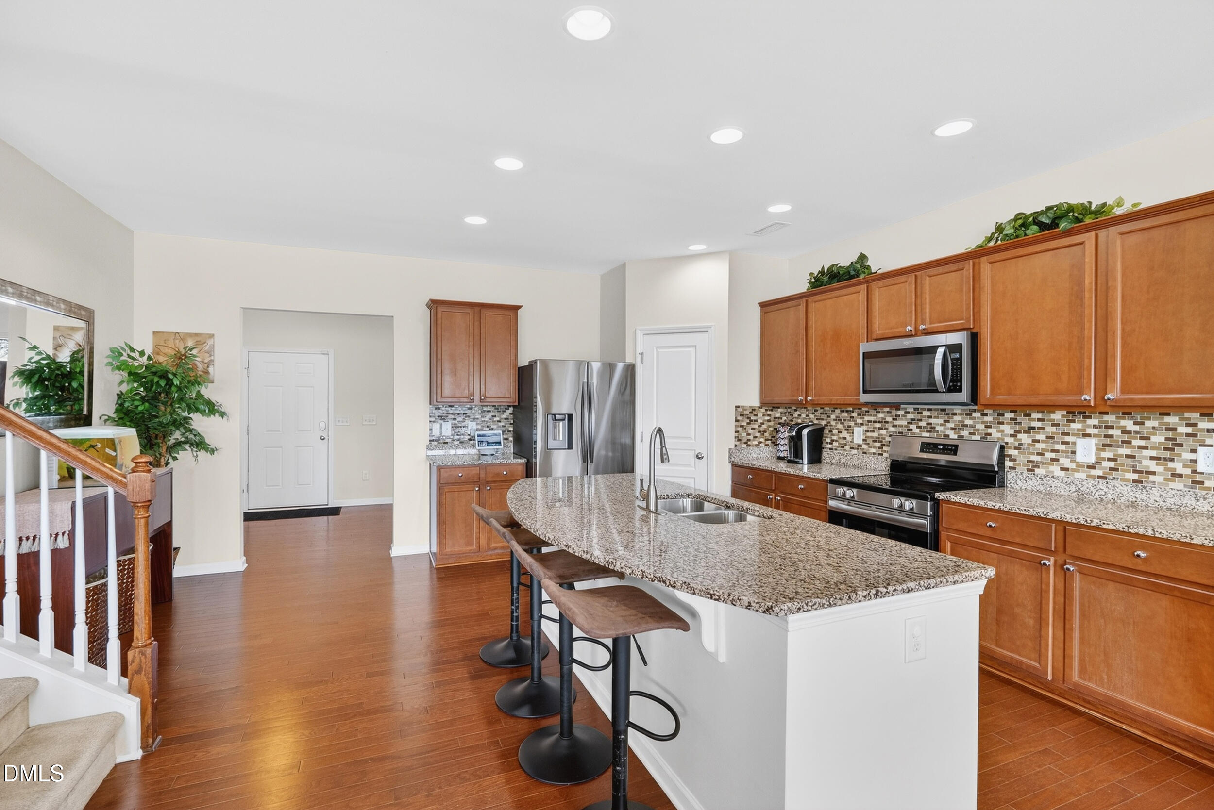 8144 Hovingham Way Raleigh, NC 27616 - Photo 5 of 37 a kitchen with counter top space cabinets and stainless steel appliances